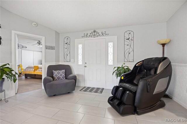 8849 SW 116th Place Rd, Ocala, FL 34481 - foyer featuring wainscoting and a ceiling fan