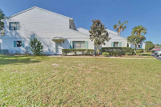 view of front of house featuring central AC unit and a front yard