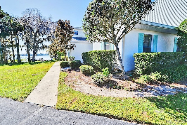 view of property exterior with a yard