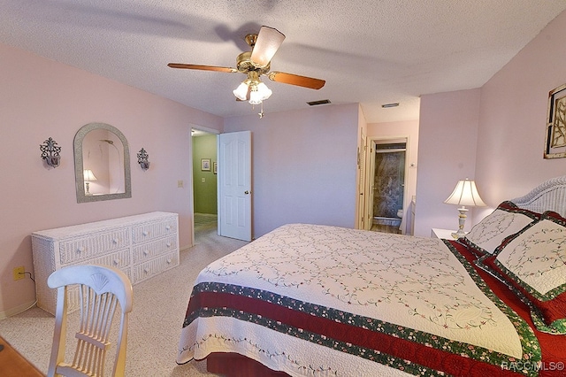 bedroom featuring ceiling fan, light carpet, and a textured ceiling