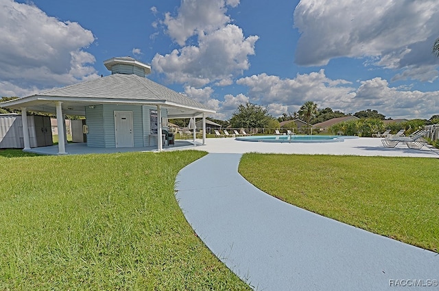 view of community with a lawn, a patio area, and a swimming pool