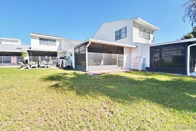 back of house featuring a sunroom, an outdoor hangout area, and a yard