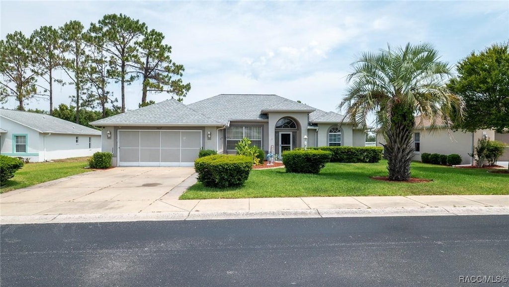 3637 E Lake Todd Dr, Hernando, FL 34442 - single story home featuring an attached garage, concrete driveway, a front lawn, and stucco siding