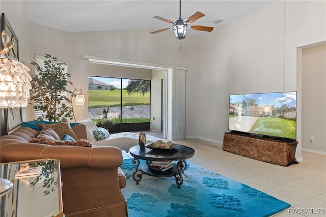 living room featuring ceiling fan, high vaulted ceiling, and light tile patterned floors