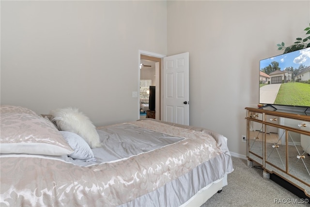 carpeted bedroom with a towering ceiling