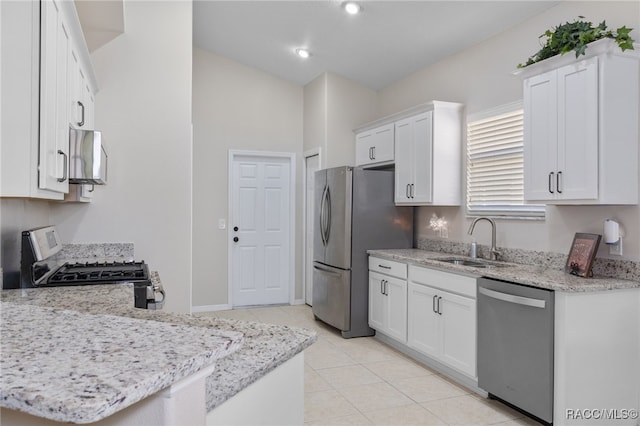 kitchen featuring light stone countertops, white cabinetry, sink, and appliances with stainless steel finishes