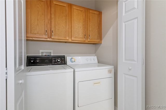 laundry area with cabinets and separate washer and dryer