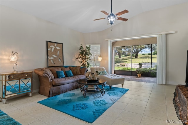 tiled living room with ceiling fan and high vaulted ceiling