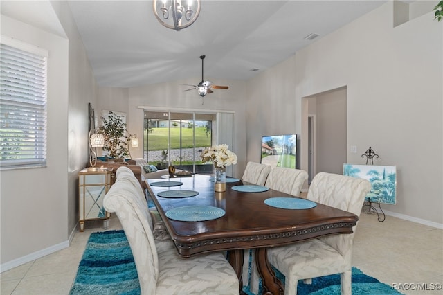 tiled dining space featuring ceiling fan, a wealth of natural light, and vaulted ceiling