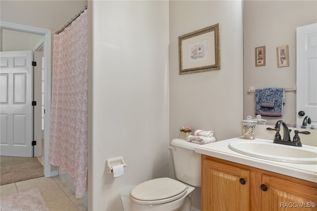 bathroom featuring tile patterned floors, vanity, curtained shower, and toilet