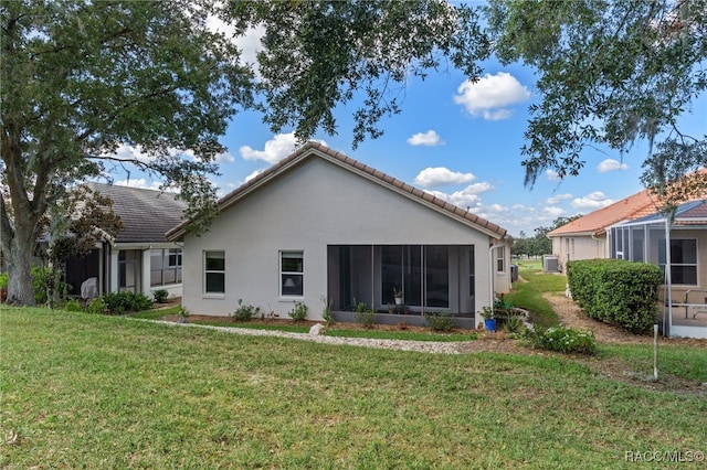 rear view of property featuring a lawn