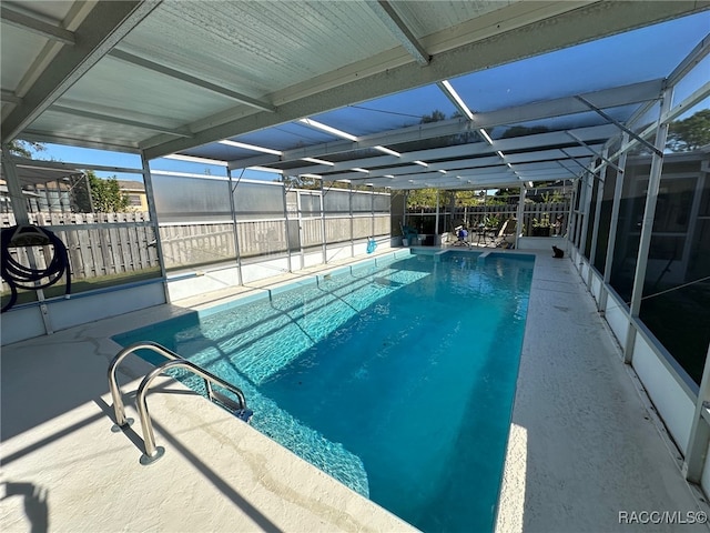 view of swimming pool with a patio and a lanai