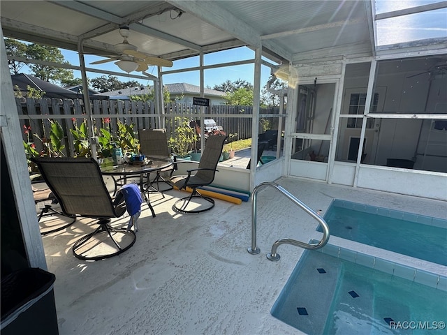 unfurnished sunroom with ceiling fan