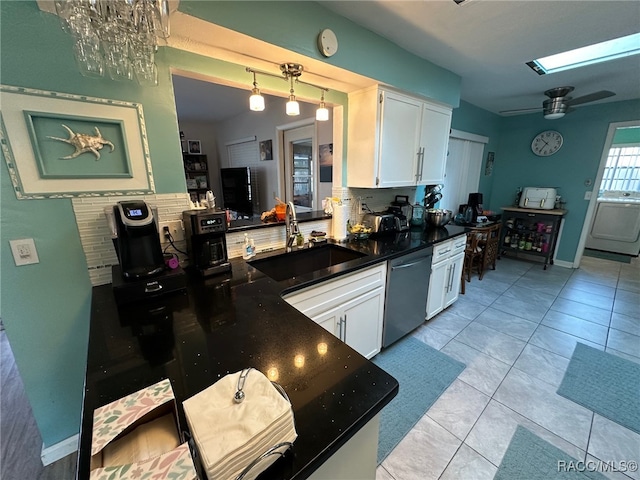 kitchen with white cabinets, sink, stainless steel dishwasher, ceiling fan, and light tile patterned floors