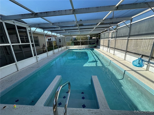 view of swimming pool with a lanai