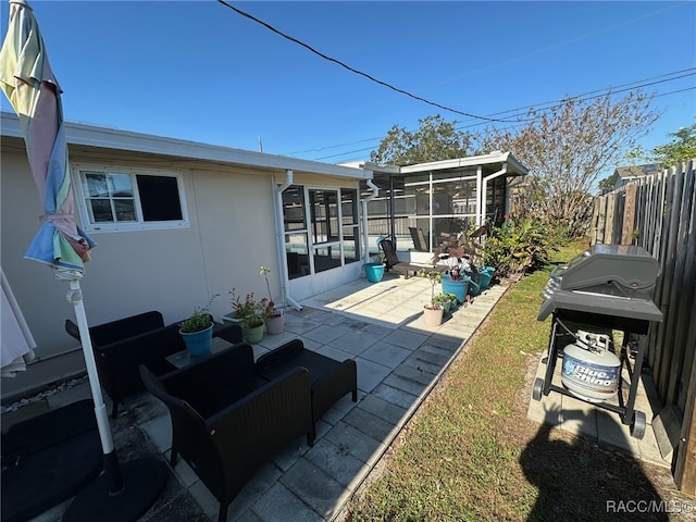 back of property featuring a patio area and a sunroom