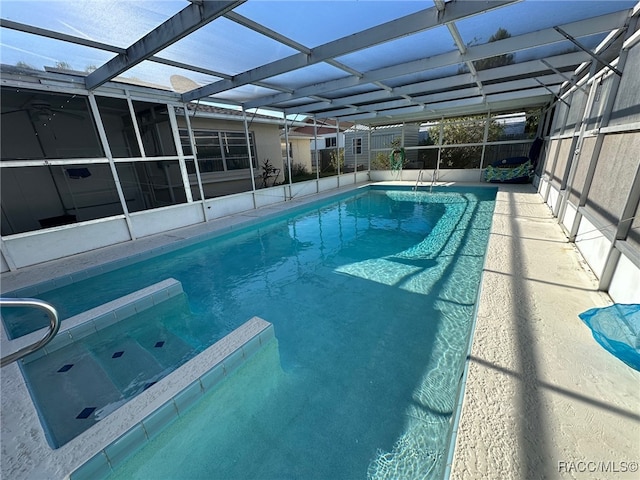 view of swimming pool with a lanai