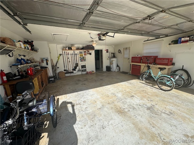 garage with water heater and a garage door opener