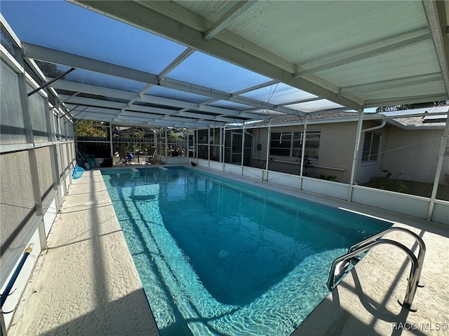 view of swimming pool with a lanai and a patio