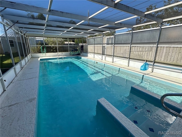 view of pool with a lanai