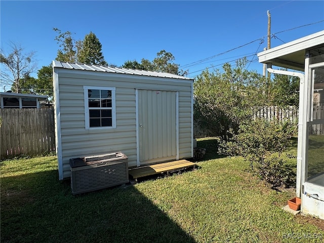 view of outdoor structure featuring a lawn