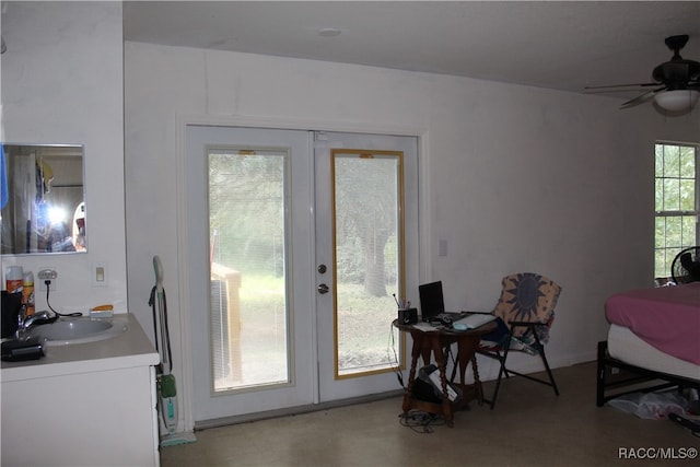 doorway with ceiling fan, a healthy amount of sunlight, sink, and french doors