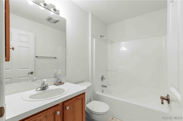 full bathroom featuring vanity, a textured ceiling, toilet, and tub / shower combination