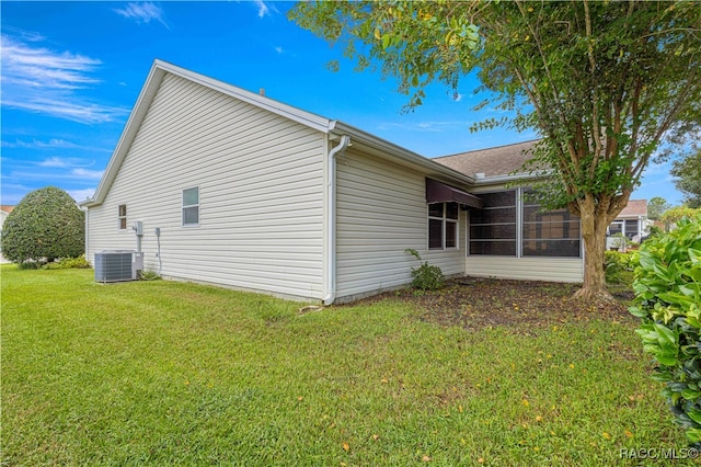 view of property exterior featuring a lawn and central air condition unit