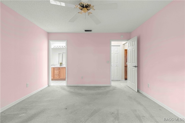 spare room with light carpet, a textured ceiling, and ceiling fan