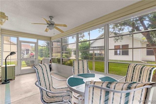 sunroom / solarium featuring ceiling fan