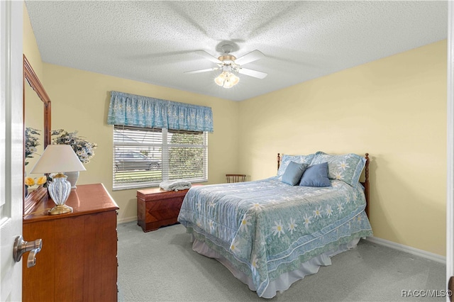 bedroom with light carpet, a textured ceiling, and ceiling fan