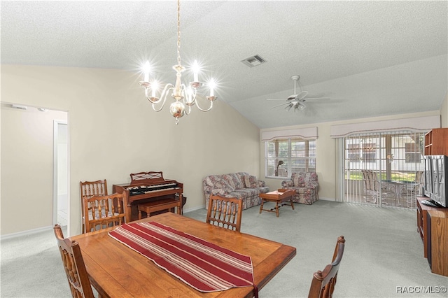 carpeted dining area featuring a textured ceiling, ceiling fan with notable chandelier, and lofted ceiling