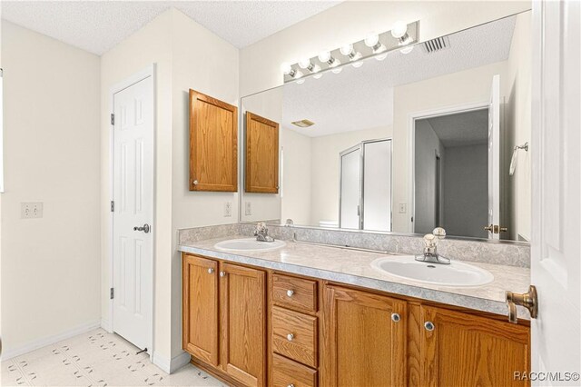 bathroom with a textured ceiling and vanity