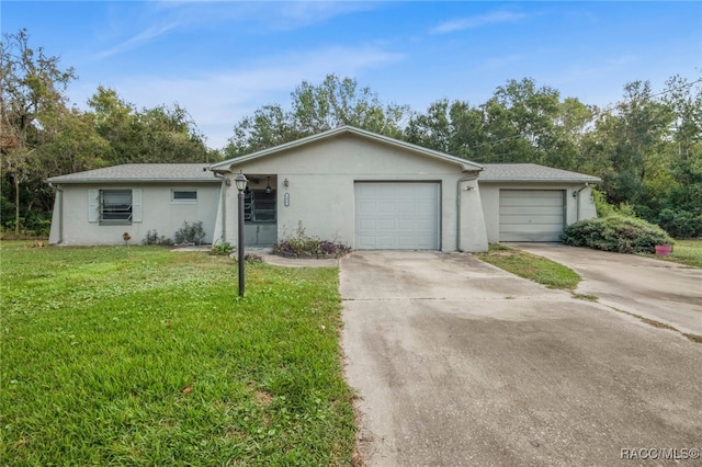 single story home featuring a garage and a front yard