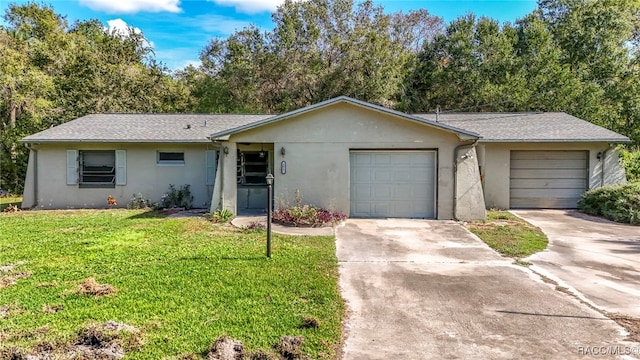 ranch-style home featuring a front lawn and a garage