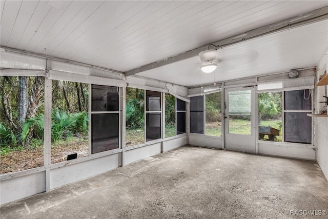 unfurnished sunroom with ceiling fan