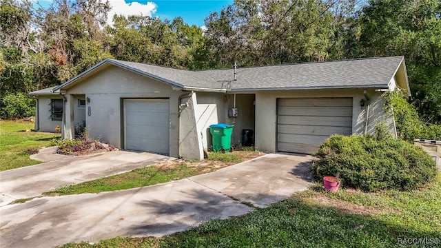 view of front of property with a front yard and a garage