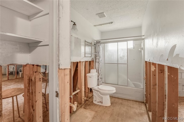 bathroom with hardwood / wood-style floors, a textured ceiling, toilet, and enclosed tub / shower combo