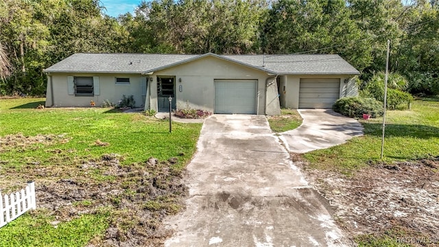 ranch-style home featuring a garage and a front lawn