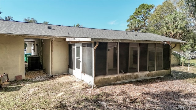 rear view of property with cooling unit and a sunroom