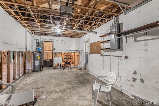 basement with electric panel, water heater, and sink