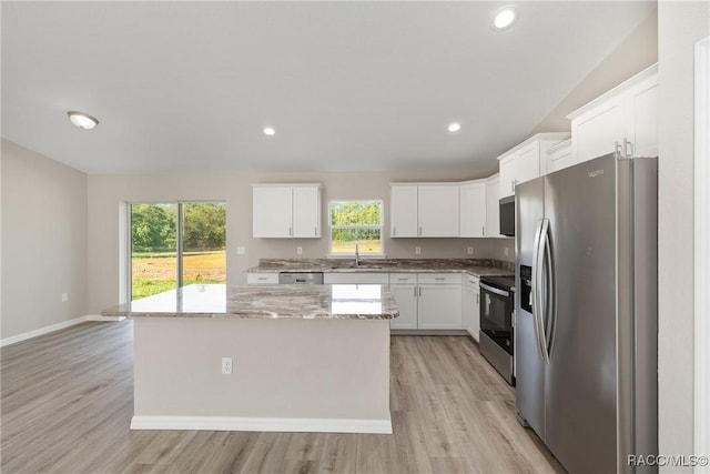895 W Gage Ln, Citrus Springs, FL 34434 - kitchen featuring stainless steel appliances, plenty of natural light, light wood-type flooring, light stone counters, and recessed lighting