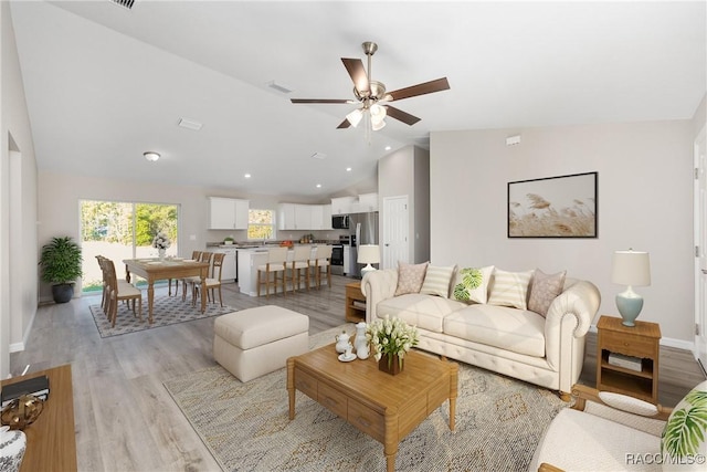 895 W Gage Ln, Citrus Springs, FL 34434 - living area featuring lofted ceiling, ceiling fan, and light wood-type flooring