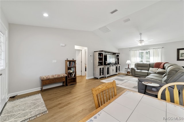 living room featuring hardwood / wood-style flooring, ceiling fan, and lofted ceiling