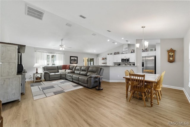 776 W Horizon Ln, Citrus Springs, FL 34434 - living area featuring lofted ceiling, light wood finished floors, ceiling fan, a chandelier, and baseboards