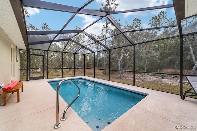 view of swimming pool featuring a lanai and a patio