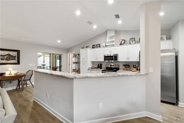 kitchen with kitchen peninsula, stainless steel appliances, light hardwood / wood-style flooring, white cabinets, and lofted ceiling