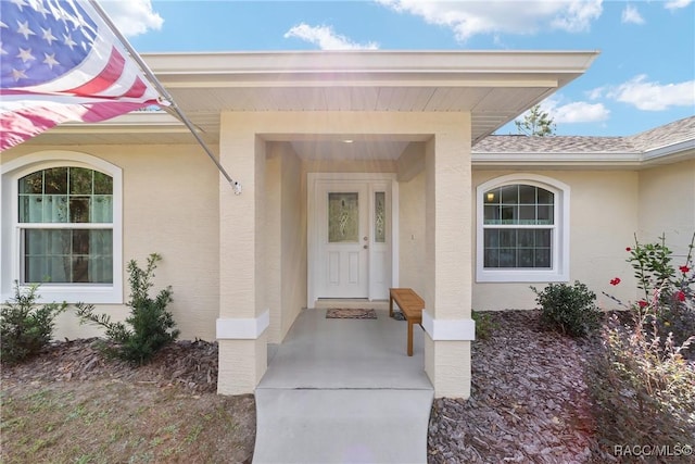 776 W Horizon Ln, Citrus Springs, FL 34434 - doorway to property with stucco siding and a shingled roof