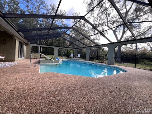 view of pool featuring a lanai and a patio