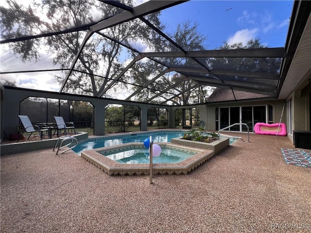 view of swimming pool featuring a lanai, an in ground hot tub, and a patio